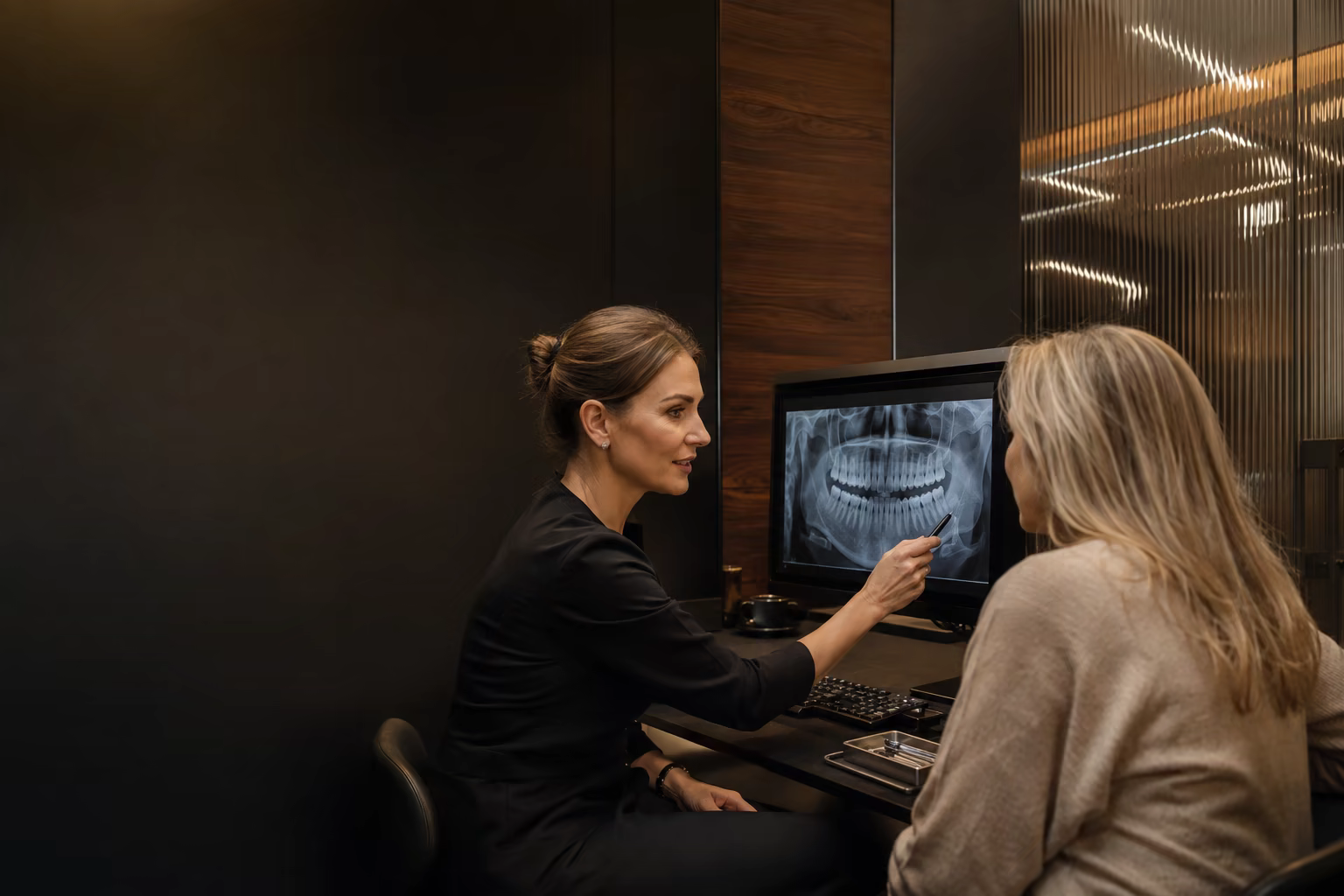 Dentist and patient discussing a dental image